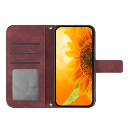 For iPhone 16 Skin Feel Sun Flower Embossed Flip Leather Phone Case with Lanyard(Wine Red) - iPhone 16 Cases by buy2fix | Online Shopping UK | buy2fix